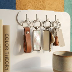 Porte-clés en acier Perle, coloris blanc, sur une étagère Aventurine.